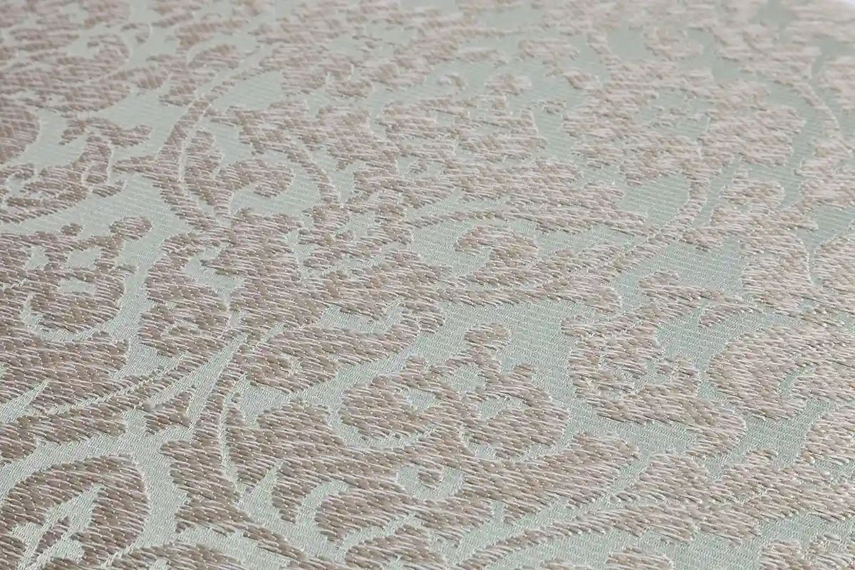 Muster Polsterbezug mit Damastmuster in Beige auf mintgrünem Grund.
